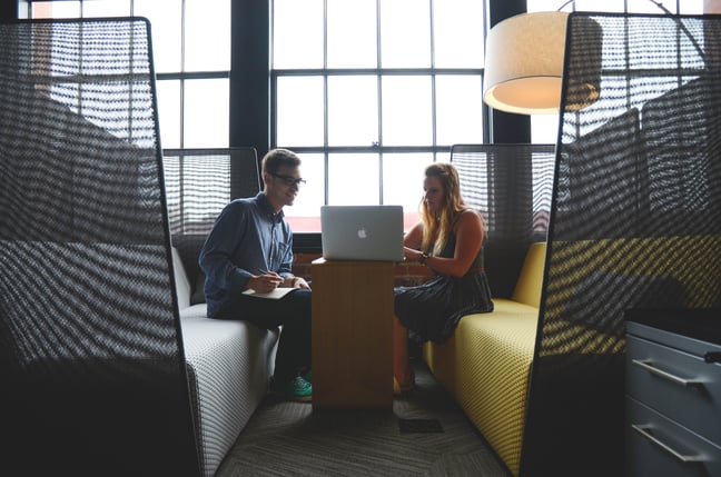 Coworkers looking at computer together