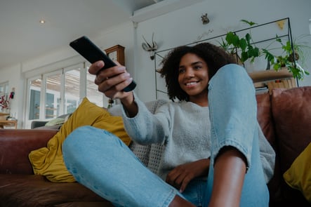 Teen on couch watching TV