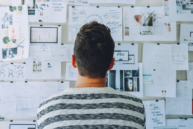 Entrepreneur looking at plans on a wall